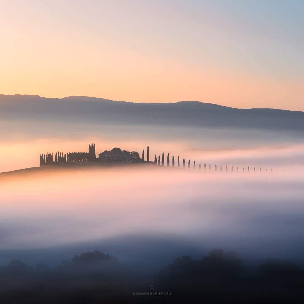 A villa in the distance in Tuscany, surrounded by a sea of fog.