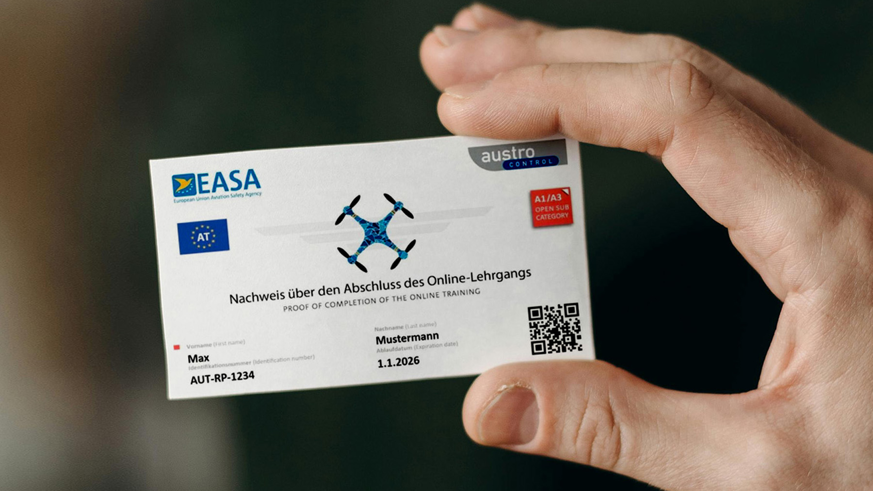 A picture, showing the EU drone license A1/A3 being held by a human hand.